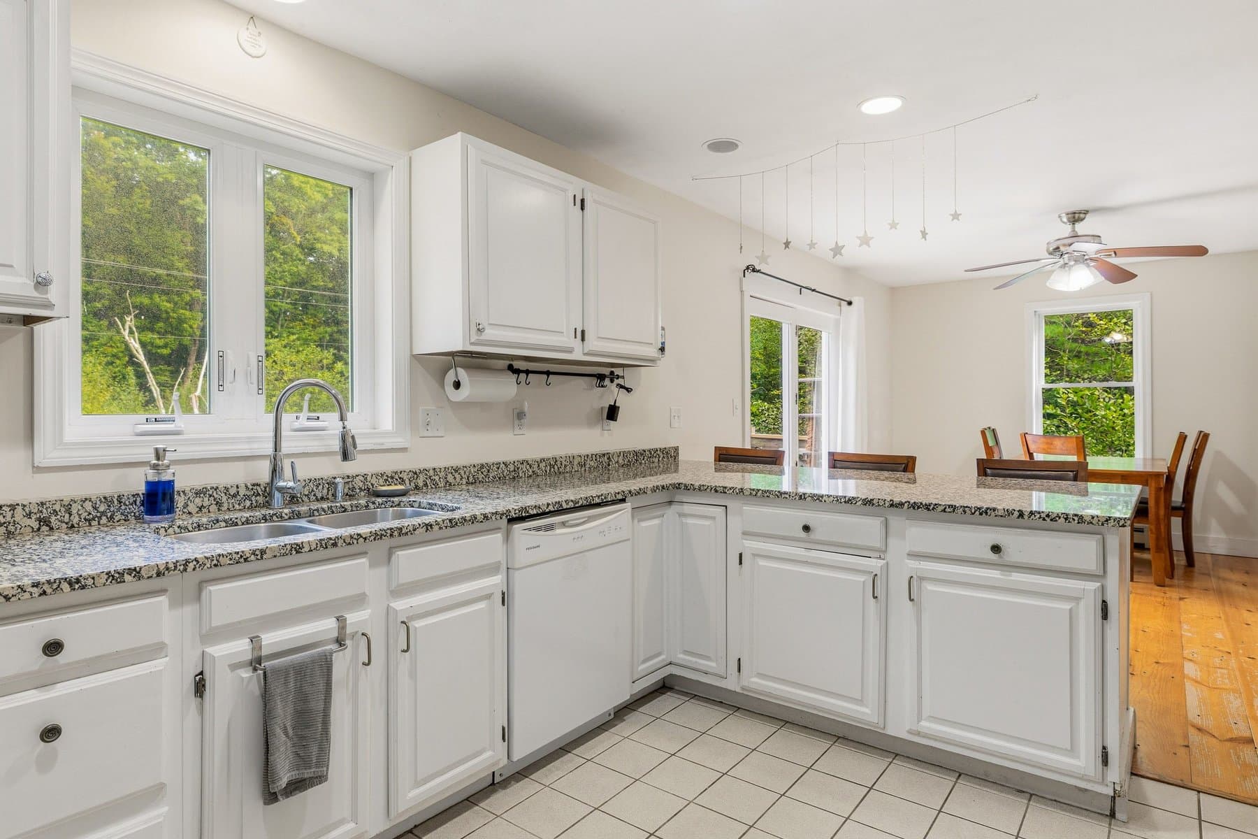 The kitchen from the sink corner, looking past the peninsula to the dining area