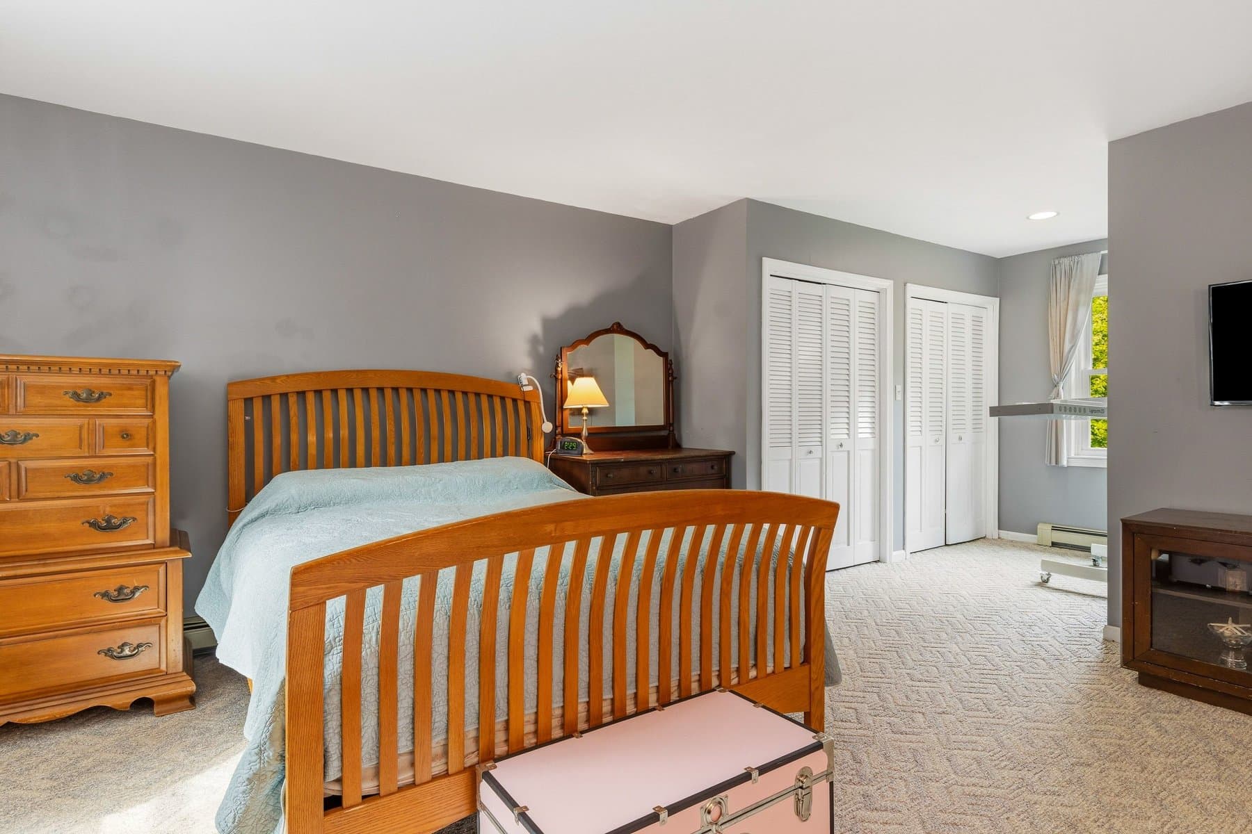 The primary bedroom's 2 double closets and the bed